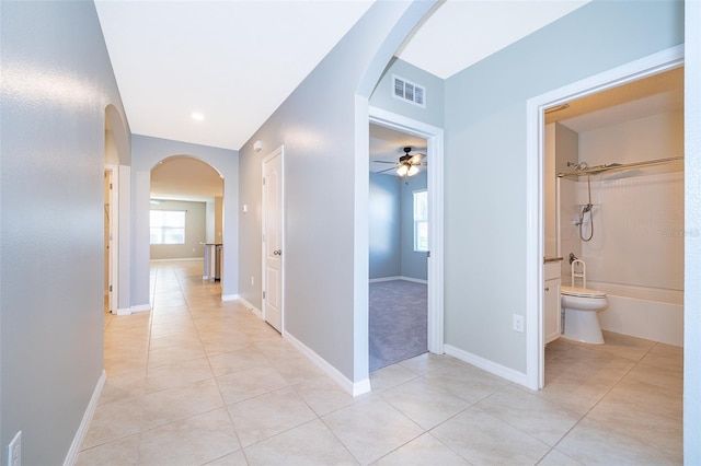 corridor with plenty of natural light and light tile patterned flooring