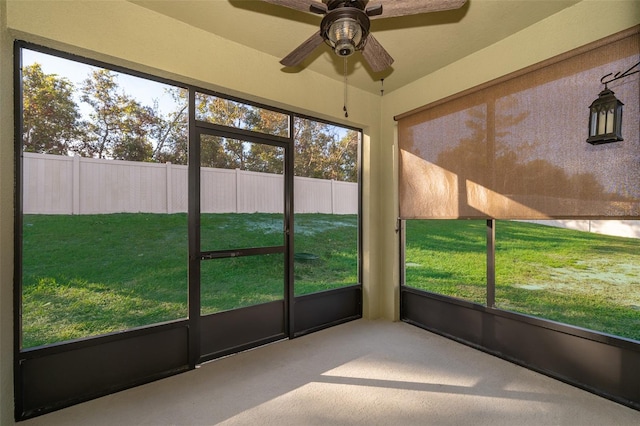 unfurnished sunroom with plenty of natural light and ceiling fan