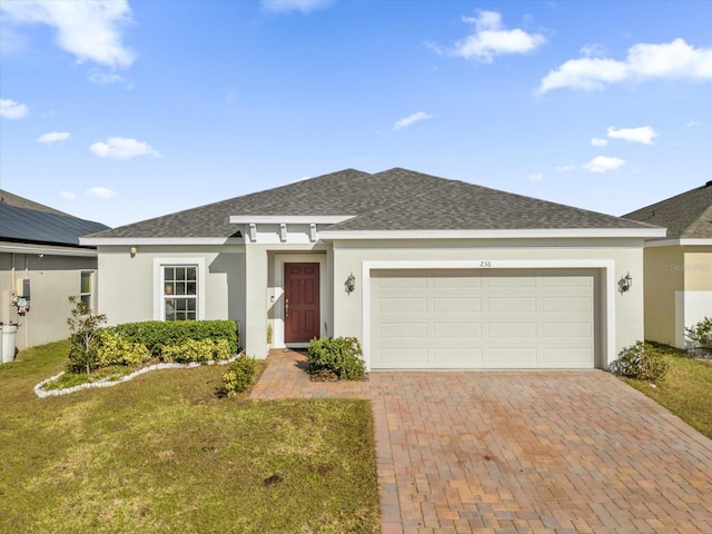 ranch-style home with a garage and a front lawn