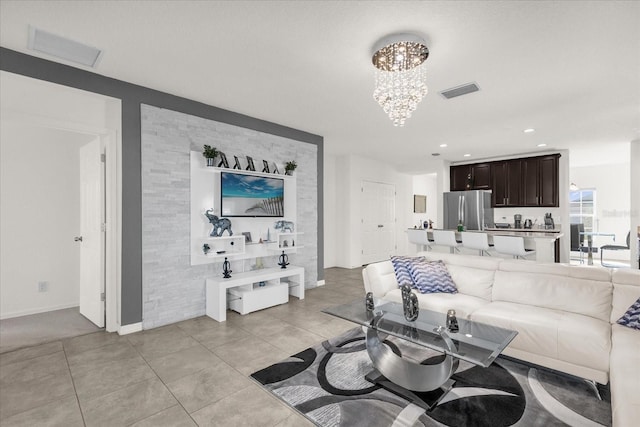 living room featuring a notable chandelier and light tile patterned flooring