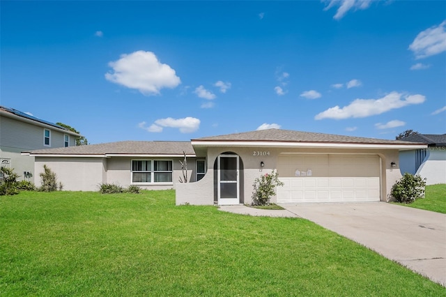 ranch-style home with a garage and a front yard