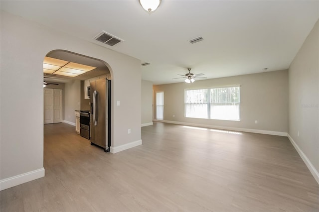 unfurnished living room with ceiling fan and light hardwood / wood-style floors