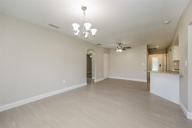 unfurnished living room featuring light hardwood / wood-style floors and ceiling fan with notable chandelier