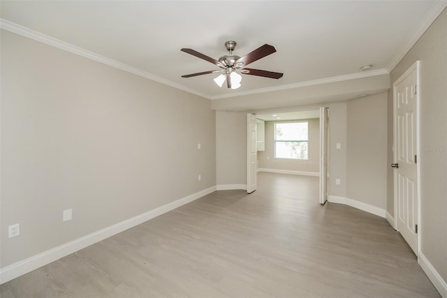 empty room featuring light hardwood / wood-style flooring, ceiling fan, and crown molding