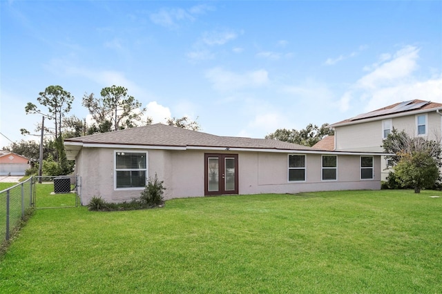 rear view of property featuring french doors and a yard