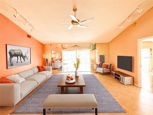 tiled living room featuring rail lighting, lofted ceiling, and a textured ceiling