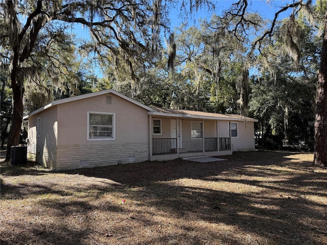 view of front of house with covered porch and central AC unit