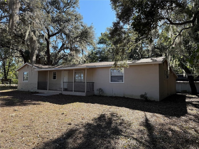 back of property with a porch