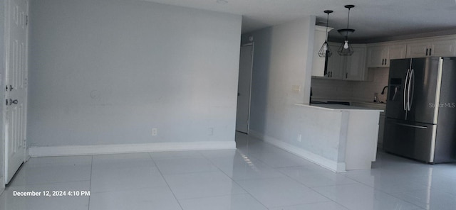 kitchen featuring stainless steel fridge with ice dispenser, light tile patterned floors, and hanging light fixtures