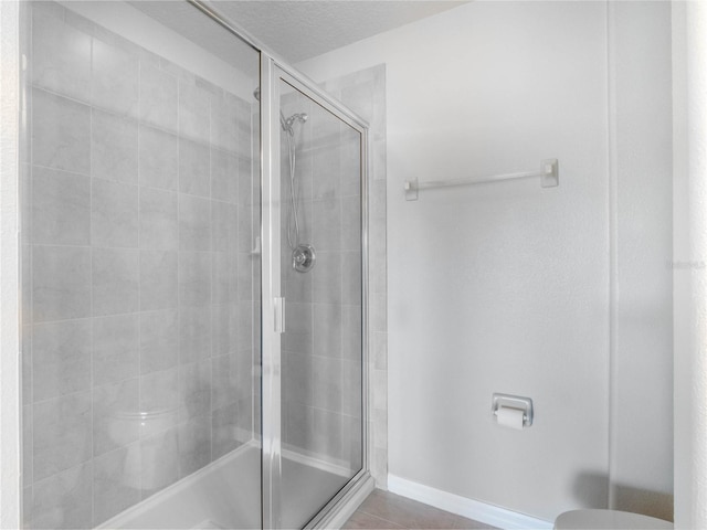 bathroom featuring tile patterned flooring and walk in shower