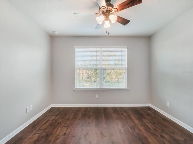 empty room featuring dark wood-type flooring and ceiling fan