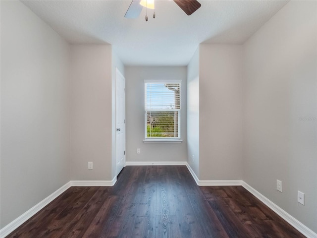 empty room featuring ceiling fan and dark hardwood / wood-style flooring