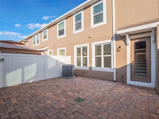 rear view of house with a patio and central air condition unit