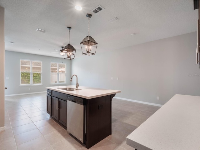 kitchen featuring light tile patterned flooring, sink, hanging light fixtures, a center island with sink, and stainless steel dishwasher