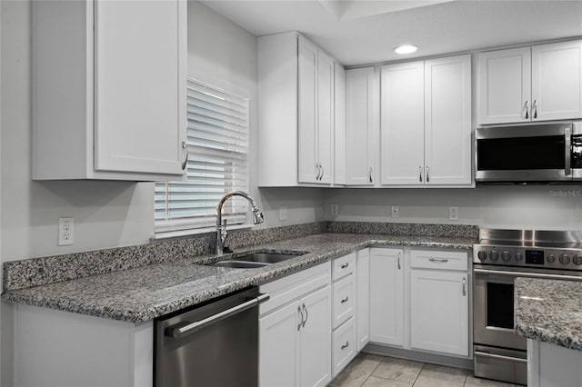 kitchen featuring white cabinets, sink, and stainless steel appliances