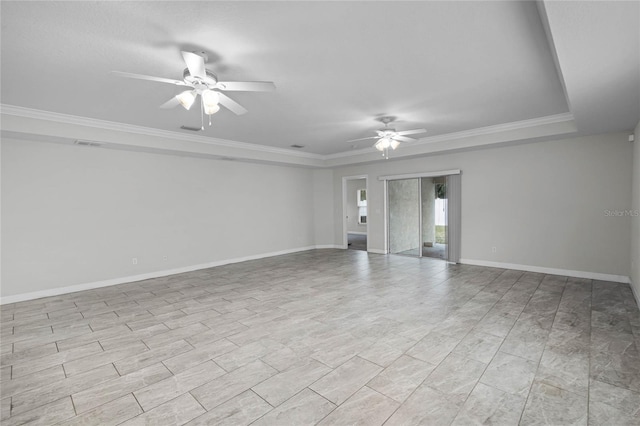 unfurnished room featuring ceiling fan, ornamental molding, and a tray ceiling