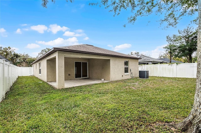 back of property featuring central air condition unit, a yard, and a patio