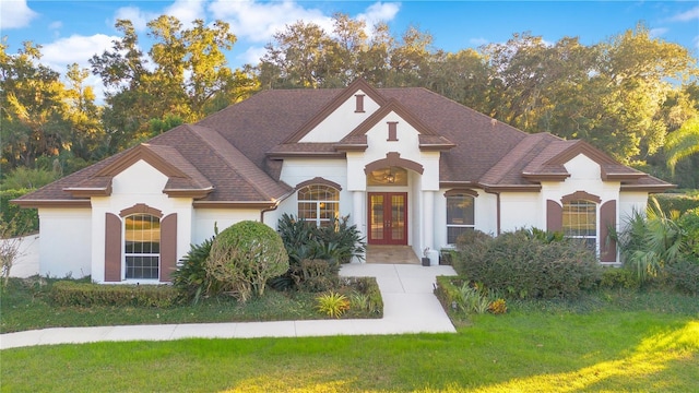 view of front of property with a front yard and french doors