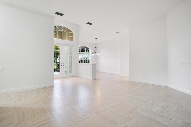 empty room featuring french doors and ornamental molding