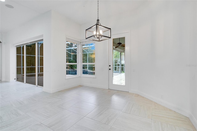 unfurnished dining area with light tile patterned floors and ceiling fan with notable chandelier