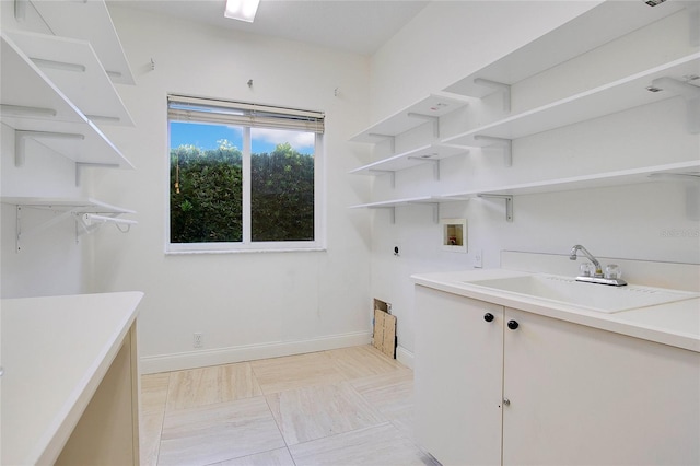 laundry area with hookup for an electric dryer, sink, and hookup for a washing machine