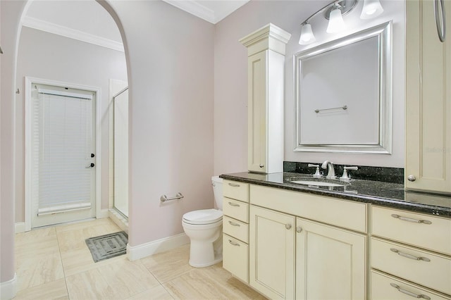 bathroom featuring vanity, a shower with door, tile patterned floors, crown molding, and toilet