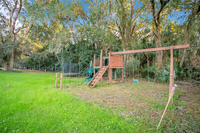 view of playground with a trampoline and a lawn