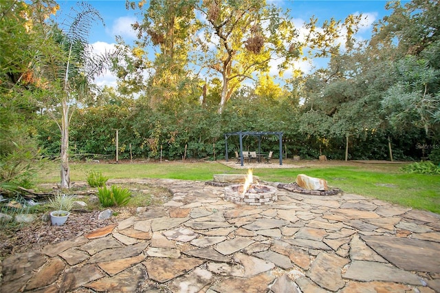 view of patio / terrace with a pergola and a fire pit