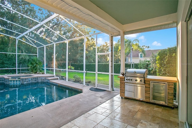 view of pool with an in ground hot tub, exterior kitchen, glass enclosure, grilling area, and a patio