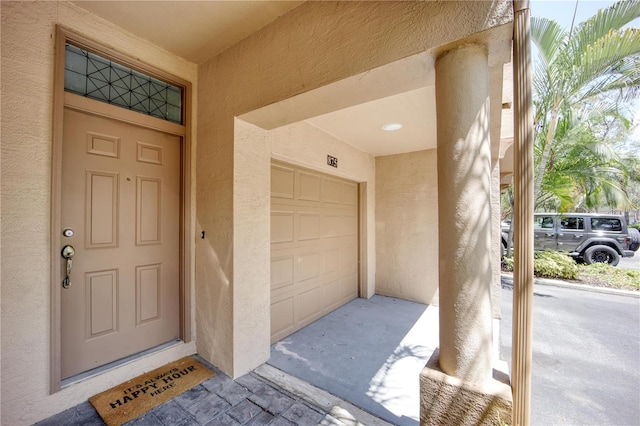 view of exterior entry featuring a garage