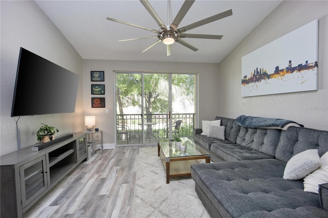 living room featuring light wood-type flooring, ceiling fan, and lofted ceiling