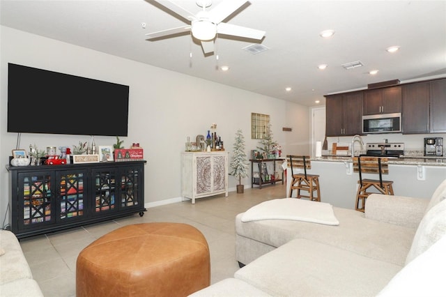 tiled living room featuring ceiling fan