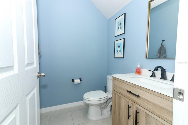 bathroom featuring tile patterned flooring, vanity, toilet, and lofted ceiling