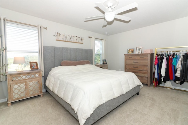 bedroom featuring ceiling fan, a closet, and light carpet