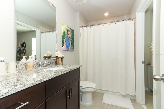 bathroom with tile patterned flooring, vanity, and toilet