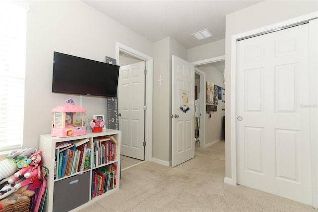 recreation room featuring light carpet