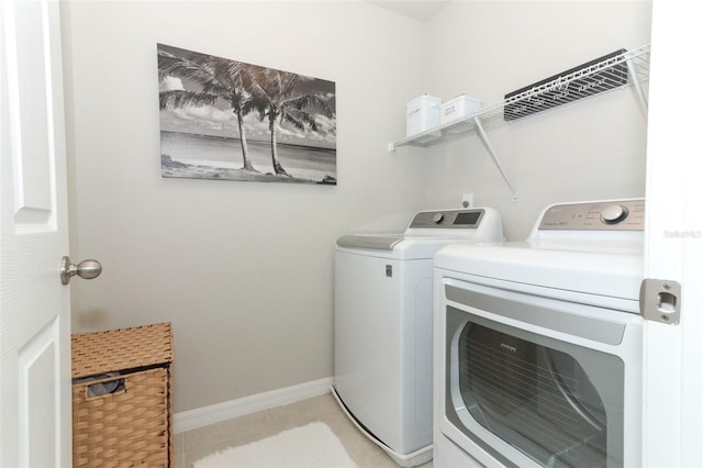 clothes washing area with washing machine and clothes dryer