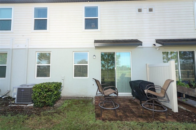 rear view of property with central AC unit