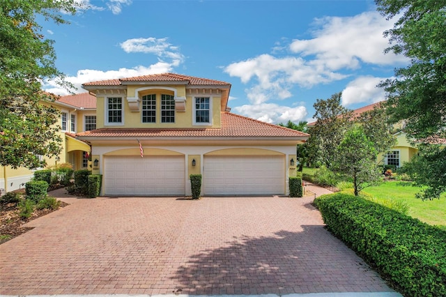 mediterranean / spanish-style home featuring a garage