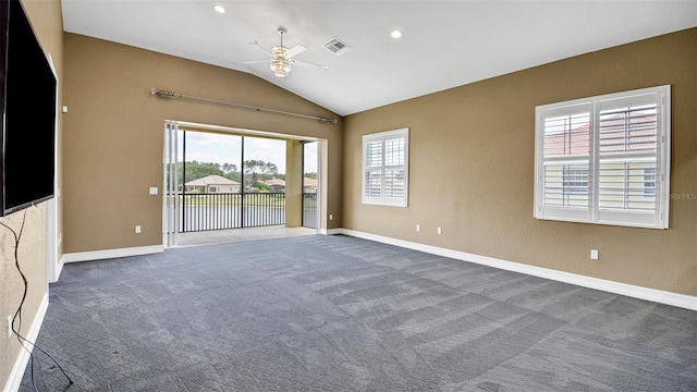 spare room featuring carpet flooring, ceiling fan, a healthy amount of sunlight, and lofted ceiling