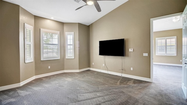 unfurnished living room featuring a wealth of natural light, carpet floors, and ceiling fan