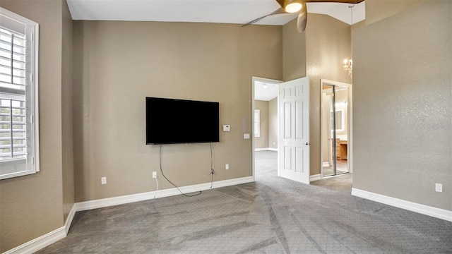 unfurnished living room featuring carpet flooring, a wealth of natural light, and ceiling fan