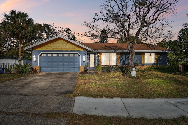 single story home with a lawn and a garage