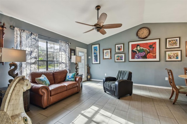 living room featuring ceiling fan and vaulted ceiling