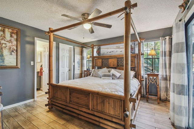 bedroom with a textured ceiling, light wood-type flooring, and ceiling fan