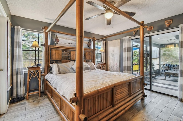 bedroom featuring access to outside, ceiling fan, light hardwood / wood-style floors, and a textured ceiling