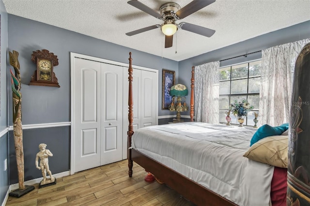 bedroom featuring ceiling fan, light hardwood / wood-style floors, and a textured ceiling