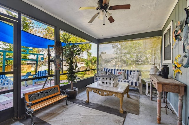 sunroom featuring ceiling fan