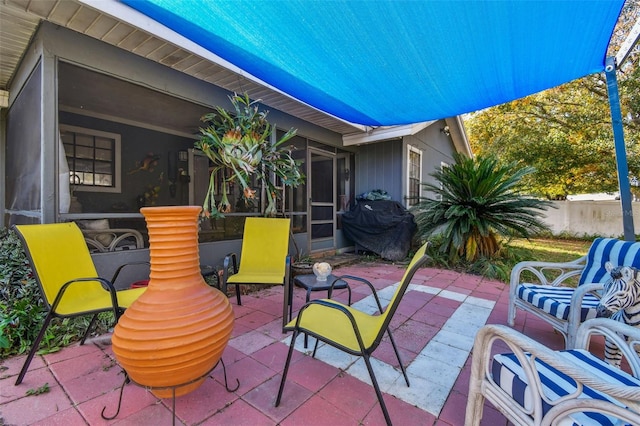 view of patio with a sunroom and area for grilling