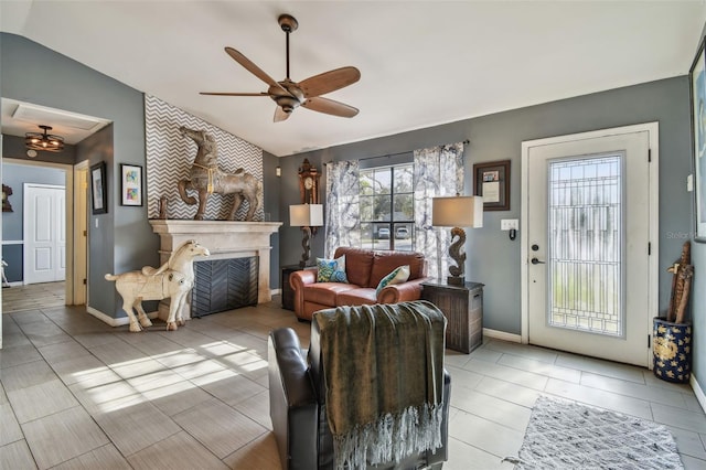 living room featuring baseboards, ceiling fan, tile patterned flooring, vaulted ceiling, and a fireplace